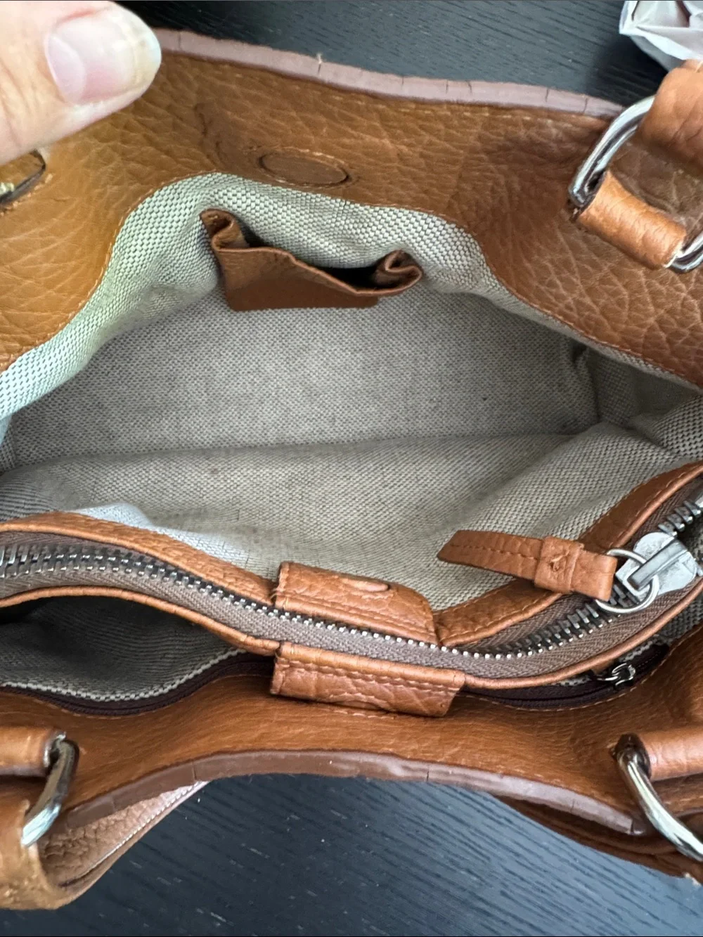 Dooney & Bourke tan pebbled leather side pockets belted satchel bag.